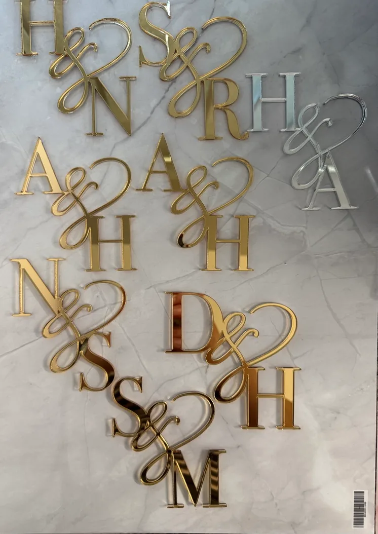 A sheet of gold, silver and rose gold two letter monograms