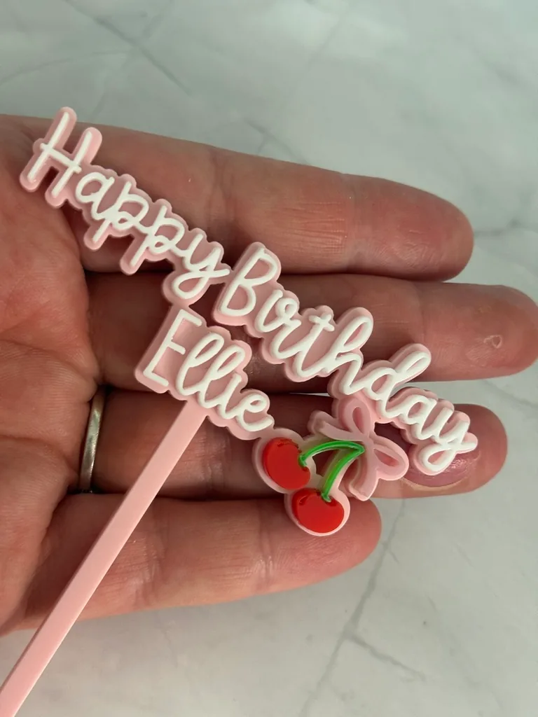 Layered pink and white Happy Birthday Ellie topper with cherries
