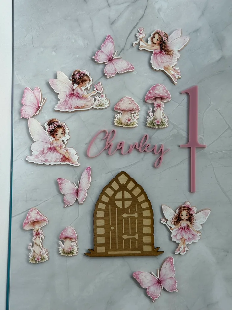 Pink fairy themed cake set with the name Charley and a number one
