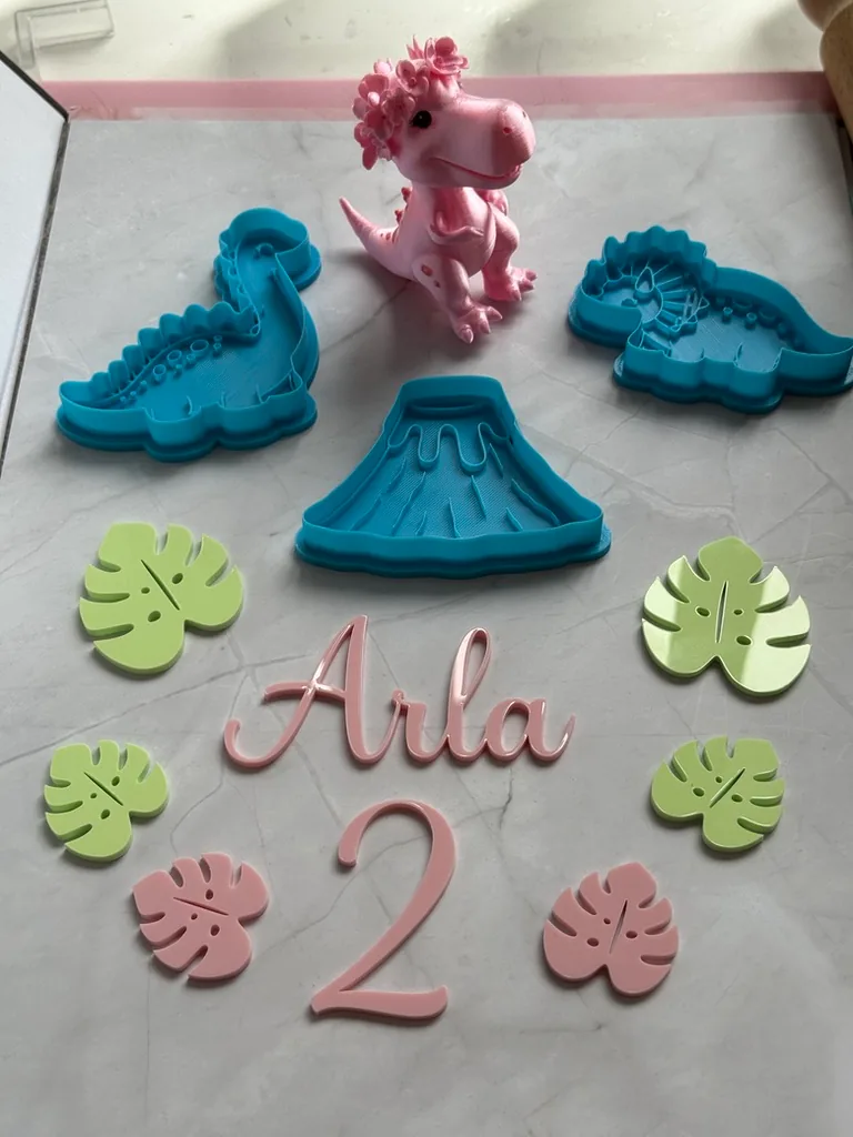 Dinosaur cutters, a printed pink T-rex and the name Arla with a number two