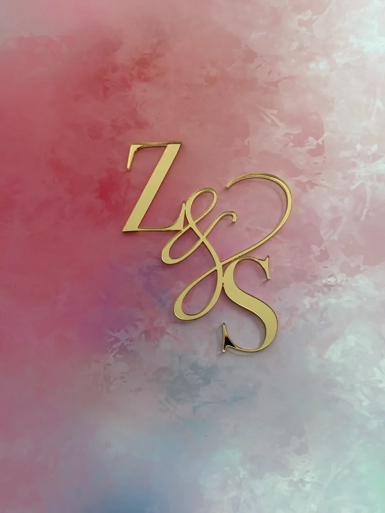 Gold mirror Z and S ampersand monogram on a pastel background